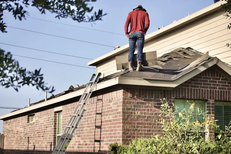 Professional roofer working on a residential roof in Leawood Estates